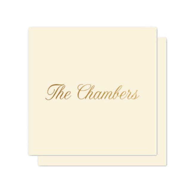 Cream-colored enclosure card with 'The Chambers' text in gold on a white background