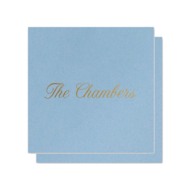 Light blue enclosure card with 'The Chambers' text in gold on a white background