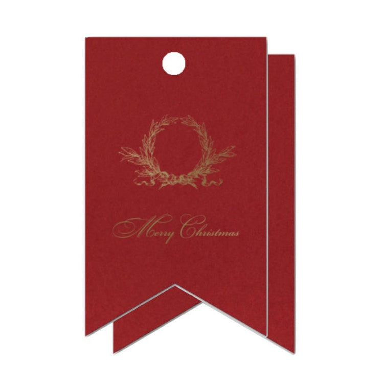 Red gift tag with gold wreath and 'Merry Christmas' text on a white background