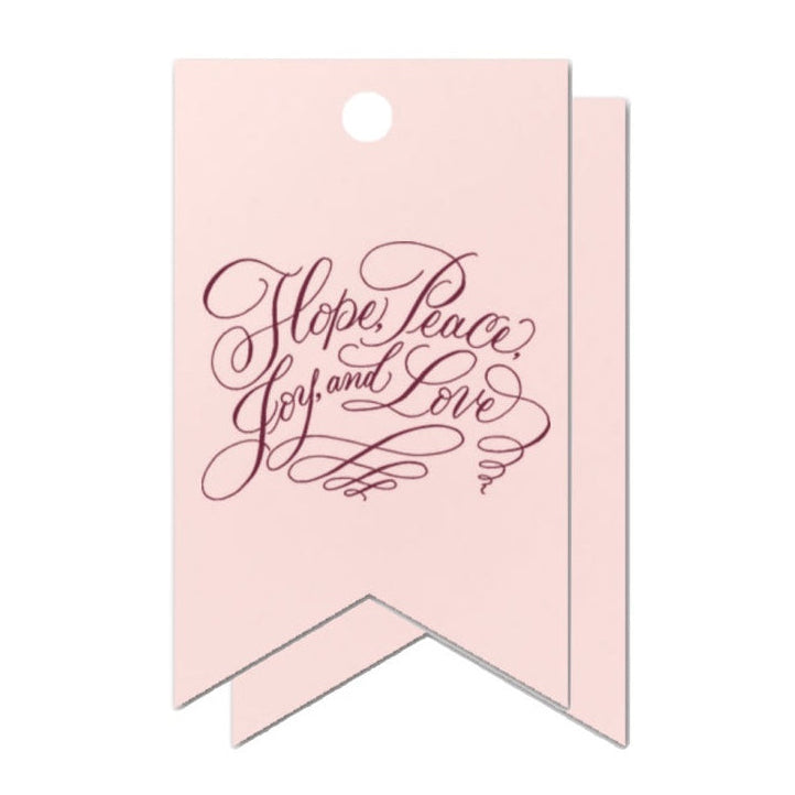 Pink gift tag with 'Hope, Peace, Joy, Love' text on a white background
