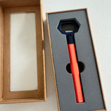 Lund London orange and navy hexagon bottle opener